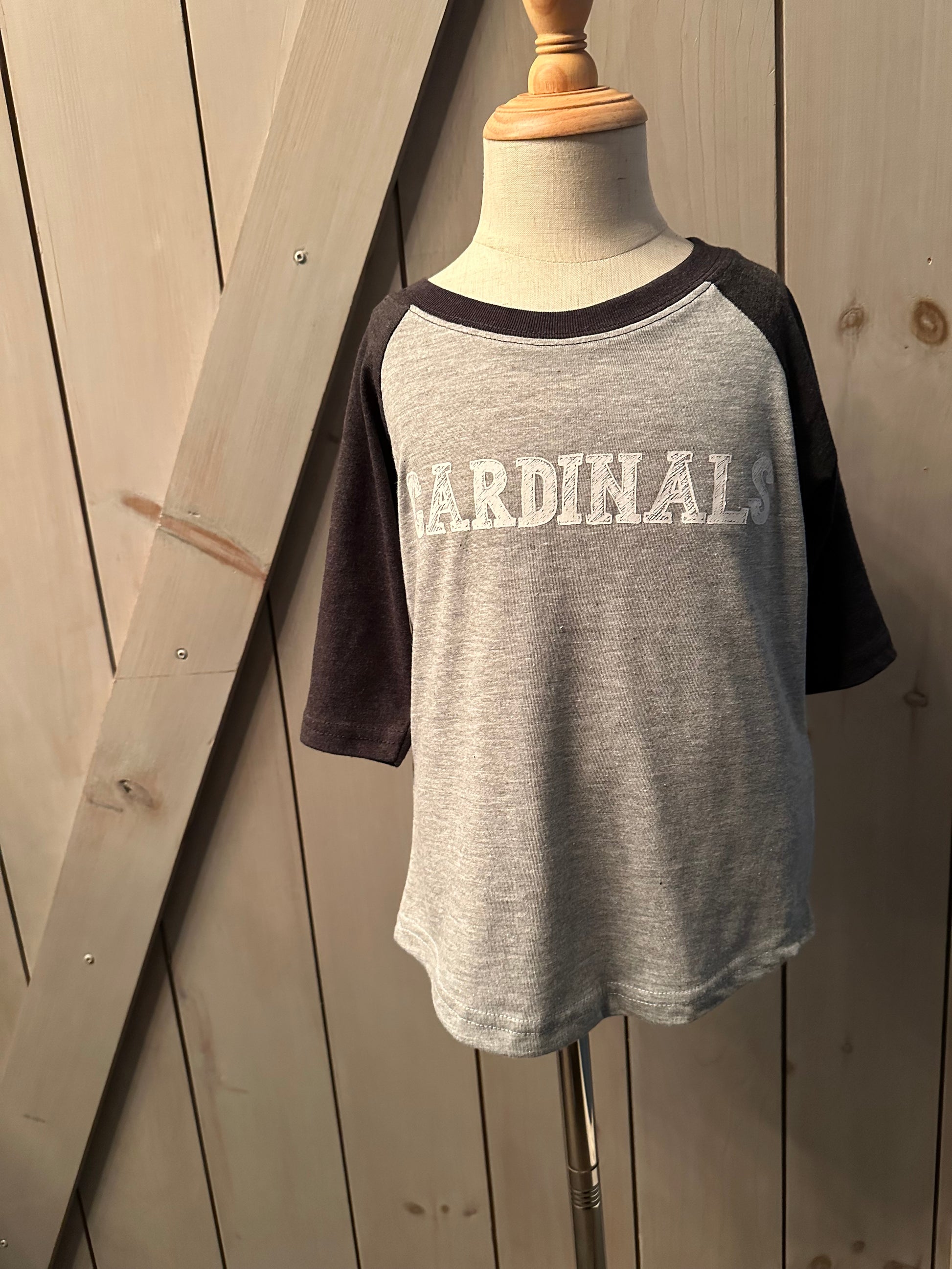 Kingston Cardinals Baseball Shirt Tri Blend Grey and Black with the word CARDINALS across the front.