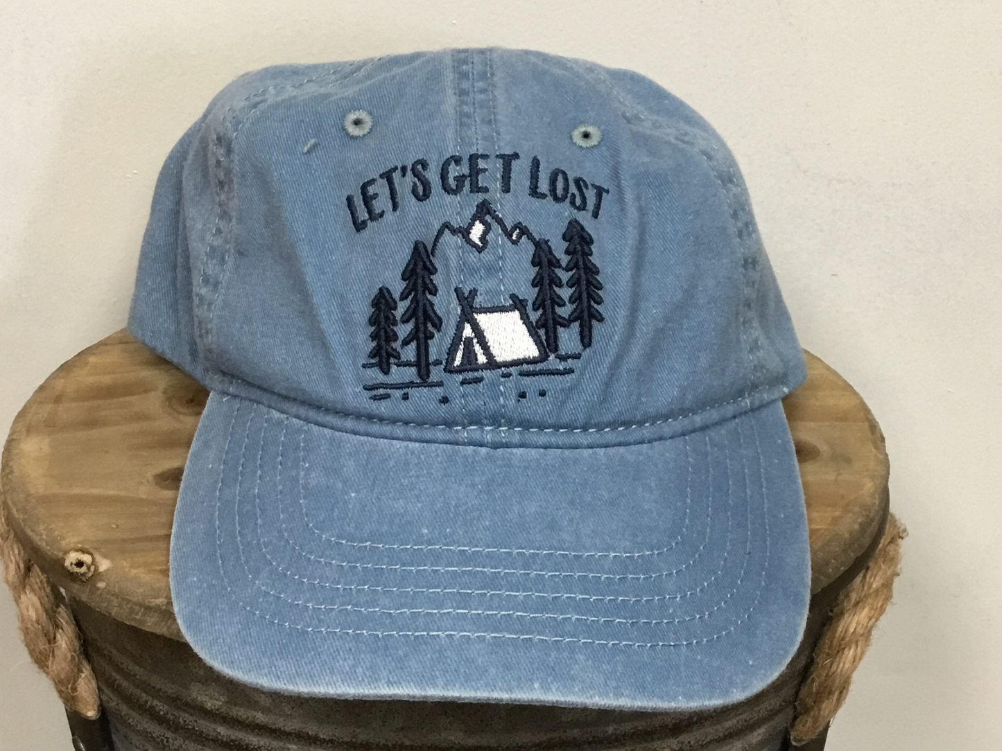 Let's Get Lost Campsite on the front of hat.